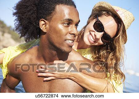 Picture - Romantic Young Couple Having Fun In Sea Together. Fotosearch