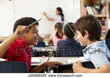 Stock Photo - Schoolboys behaving badly in class. Fotosearch