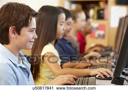 Schoolchildren working on computers View Large Photo Image Stock Image - Schoolchildren working on computers. Fotosearch