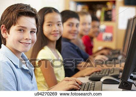Stock Photo - Schoolchildren working on computers. Fotosearch