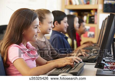 Schoolchildren working on computers View Large Photo Image Stock Photograph - Schoolchildren working on computers. Fotosearch