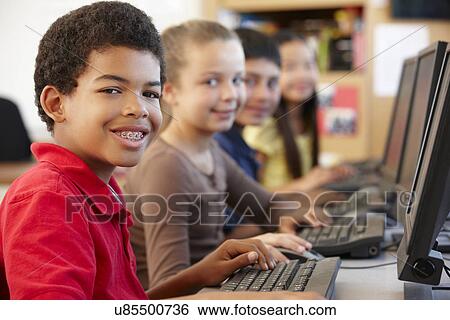 Schoolchildren working on computers View Large Photo Image Stock Photograph - Schoolchildren working on computers. Fotosearch