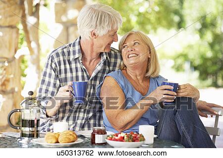 Senior couple eating breakfast outdoors View Large Photo Image Stock Image - Senior couple eating breakfast outdoors. Fotosearch