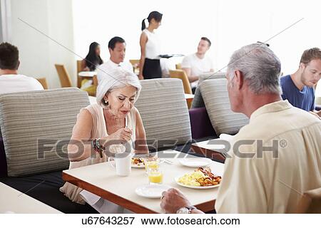 Stock Photo - Senior Couple Enjoying Breakfast In Hotel Restaurant. Fotosearch