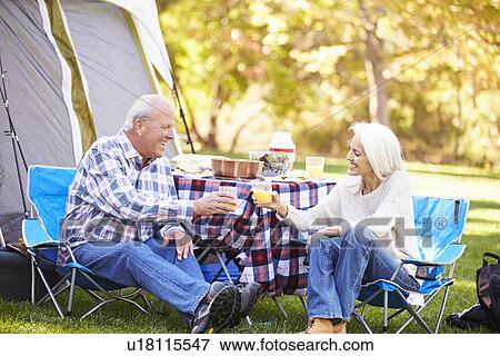 Senior Couple Enjoying Camping Holiday In Countryside View Large Photo Image Stock Photo - Senior Couple Enjoying Camping Holiday In Countryside. Fotosearch