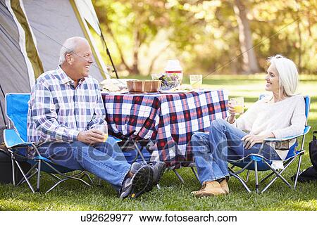 Senior Couple Enjoying Camping Holiday In Countryside View Large Photo Image Stock Photo - Senior Couple Enjoying Camping Holiday In Countryside. Fotosearch