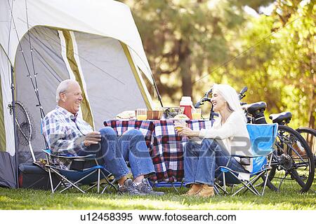 Senior Couple Enjoying Camping Holiday In Countryside View Large Photo Image Stock Photography - Senior Couple Enjoying Camping Holiday In Countryside. Fotosearch