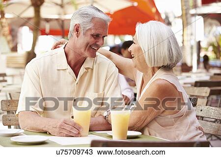 Senior Couple Enjoying Drink In Outdoor Cafe View Large Photo Image Stock Image - Senior Couple Enjoying Drink In Outdoor Cafe. Fotosearch