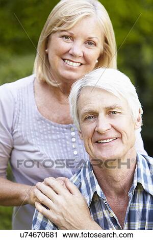 Stock Image - Senior couple in garden. Fotosearch