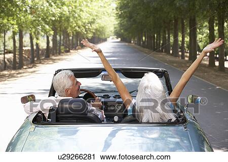 Stock Image - Senior couple in sports car. Fotosearch
