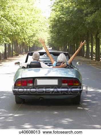 Stock Image - Senior couple in sports car. Fotosearch
