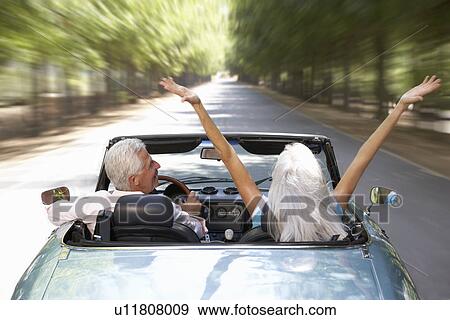 Stock Photo - Senior couple in sports car. Fotosearch