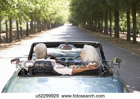 Stock Photo - Senior couple in sports car. Fotosearch