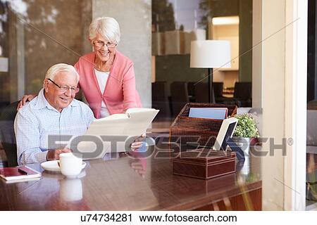 Senior Couple Looking At Photo Album Through Window View Large Photo Image Stock Image - Senior Couple Looking At Photo Album Through Window. Fotosearch