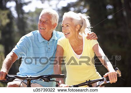 Stock Image - Senior couple on bicycles. Fotosearch