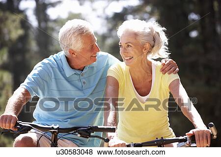 Stock Photo - Senior couple on bicycles. Fotosearch