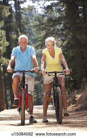 Stock Image - Senior couple on country bike ride. Fotosearch