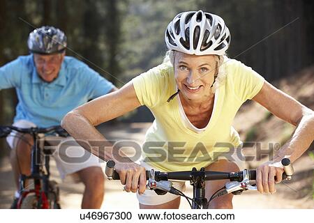 Stock Image - Senior couple on country bike ride. Fotosearch