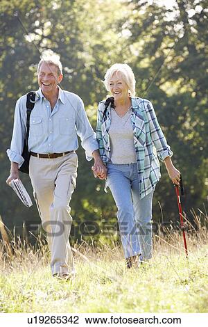 Stock Image - Senior couple on country walk. Fotosearch
