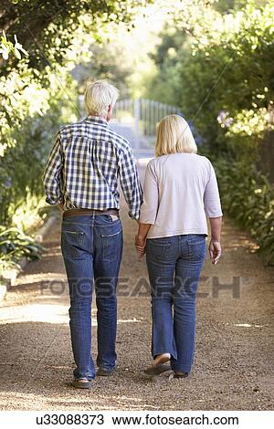 Stock Image - Senior couple on country walk. Fotosearch