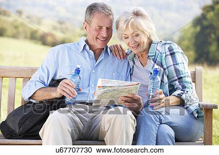 Stock Image - Senior couple on country walk. Fotosearch