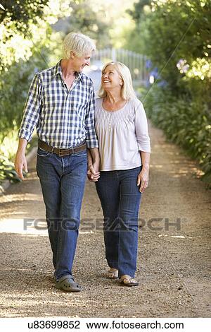 Senior couple on country walk View Large Photo Image Stock Image - Senior couple on country walk. Fotosearch