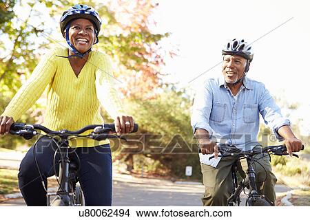 Picture - Senior Couple On Cycle Ride In Countryside. Fotosearch
