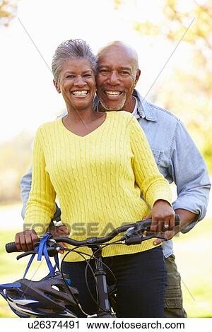 Senior Couple On Cycle Ride In Countryside View Large Photo Image Stock Image - Senior Couple On Cycle Ride In Countryside. Fotosearch