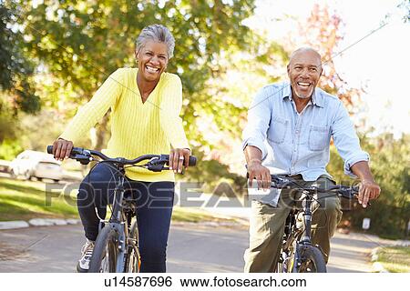 Stock Photograph - Senior Couple On Cycle Ride In Countryside. Fotosearch