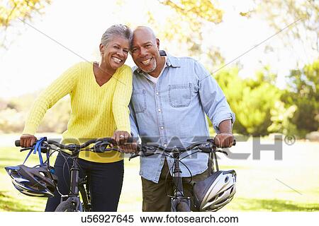 Stock Photography - Senior Couple On Cycle Ride In Countryside. Fotosearch