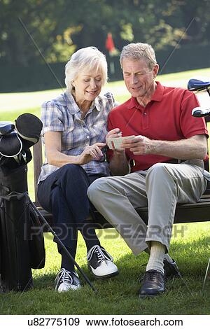 Senior couple on golf course View Large Photo Image Stock Photo - Senior couple on golf course. Fotosearch