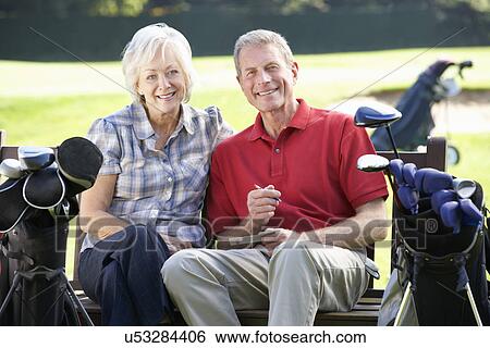 Stock Photograph - Senior couple on golf course. Fotosearch