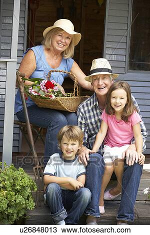 Senior couple on veranda with grandchildren View Large Photo Image Stock Image - Senior couple on veranda with grandchildren. Fotosearch