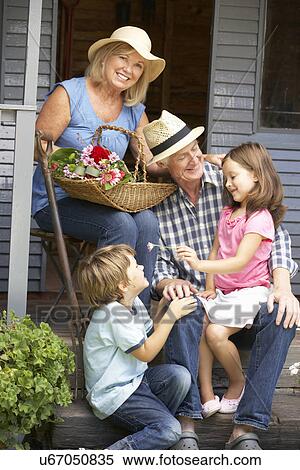 Senior couple on veranda with grandchildren View Large Photo Image Stock Photography - Senior couple on veranda with grandchildren. Fotosearch