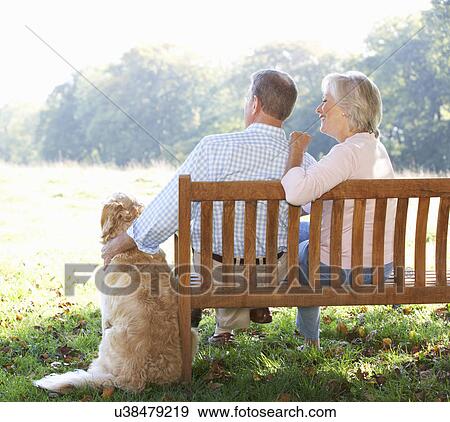 Senior couple outdoors with dog View Large Photo Image Stock Photo - Senior couple outdoors with dog. Fotosearch