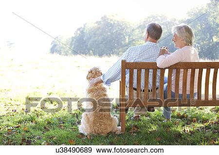 Senior couple outdoors with dog View Large Photo Image Stock Photo - Senior couple outdoors with dog. Fotosearch