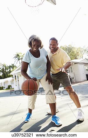 Senior Couple Playing Basketball Together View Large Photo Image Stock Image - Senior Couple Playing Basketball Together. Fotosearch