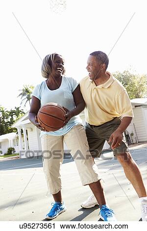 Senior Couple Playing Basketball Together View Large Photo Image Stock Image - Senior Couple Playing Basketball Together. Fotosearch