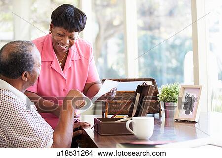 Picture - Senior Couple Putting Letter Into Keepsake Box. Fotosearch