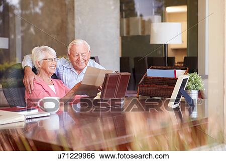 Stock Photograph - Senior Couple Putting Letter Into Keepsake Box. Fotosearch