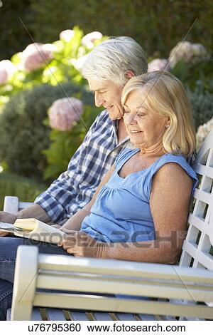 Senior couple reading in garden View Large Photo Image Stock Image - Senior couple reading in garden. Fotosearch