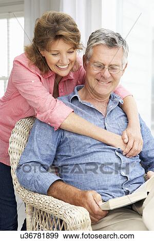 Senior couple relaxing at home View Large Photo Image Stock Photo - Senior couple relaxing at home. Fotosearch