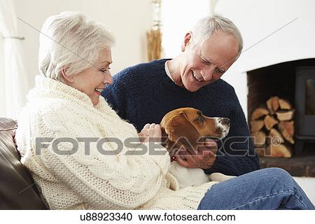 Senior Couple Relaxing At Home With Pet Dog View Large Photo Image Stock Image - Senior Couple Relaxing At Home With Pet Dog. Fotosearch