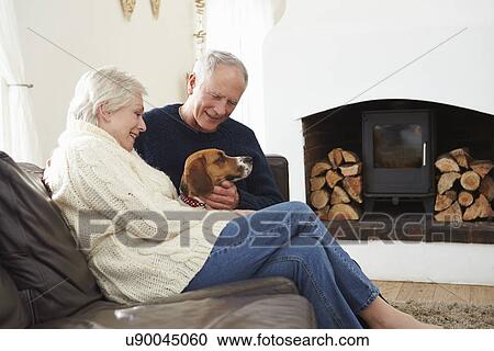 Senior Couple Relaxing At Home With Pet Dog View Large Photo Image Stock Image - Senior Couple Relaxing At Home With Pet Dog. Fotosearch