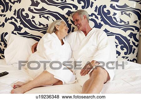 Stock Photo - Senior Couple Relaxing In Hotel Room . Fotosearch