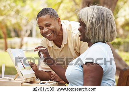 Senior Couple Sitting At Outdoor Table Painting Landscape View Large Photo Image Stock Photo - Senior Couple Sitting At Outdoor Table Painting Landscape. Fotosearch