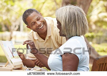 Senior Couple Sitting At Outdoor Table Painting Landscape View Large Photo Image Stock Photograph - Senior Couple Sitting At Outdoor Table Painting Landscape. Fotosearch