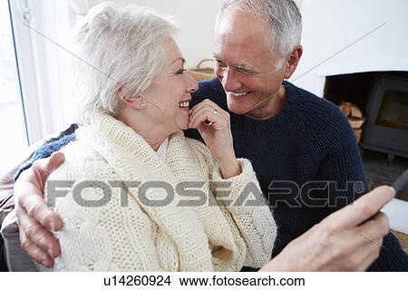 Picture - Senior Couple Sitting On Sofa And Relaxing. Fotosearch