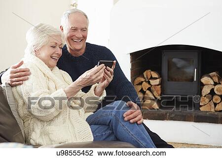 Senior Couple Sitting On Sofa Taking Selfie View Large Photo Image Stock Image - Senior Couple Sitting On Sofa Taking Selfie. Fotosearch