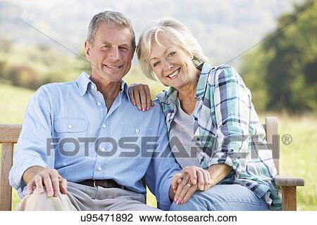 Senior couple sitting outdoors View Large Photo Image Stock Image - Senior couple sitting outdoors. Fotosearch